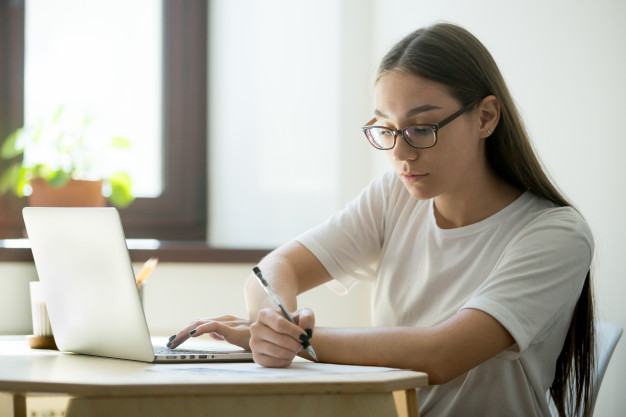 A woman does marketing research on her computer