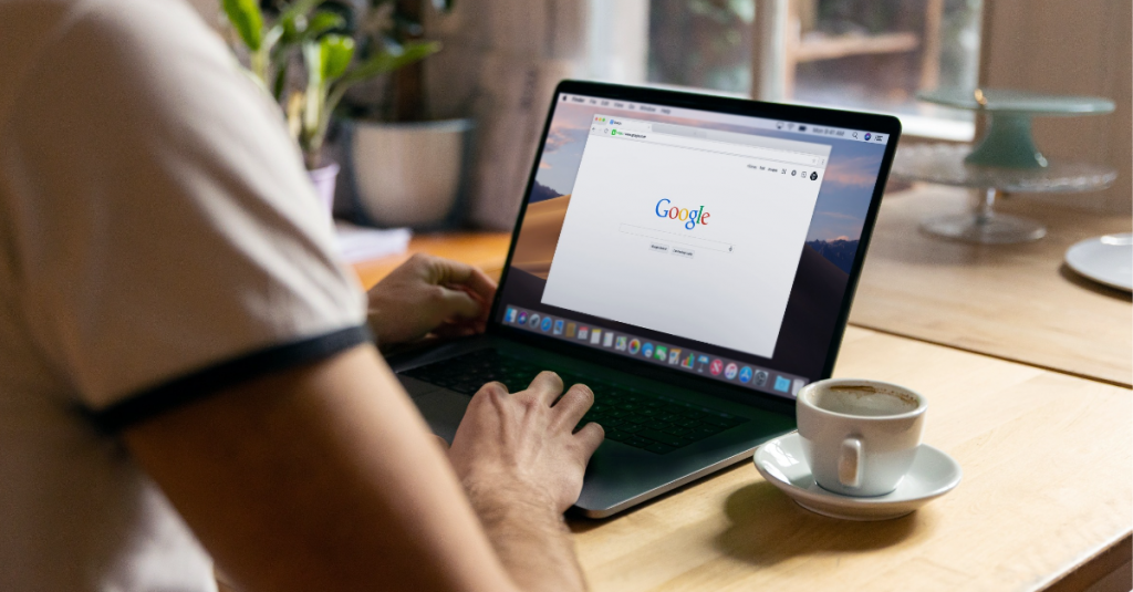 Over shoulder view of laptop with Google search on the screen