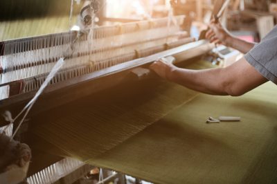 Employee working with fabric in a factory.