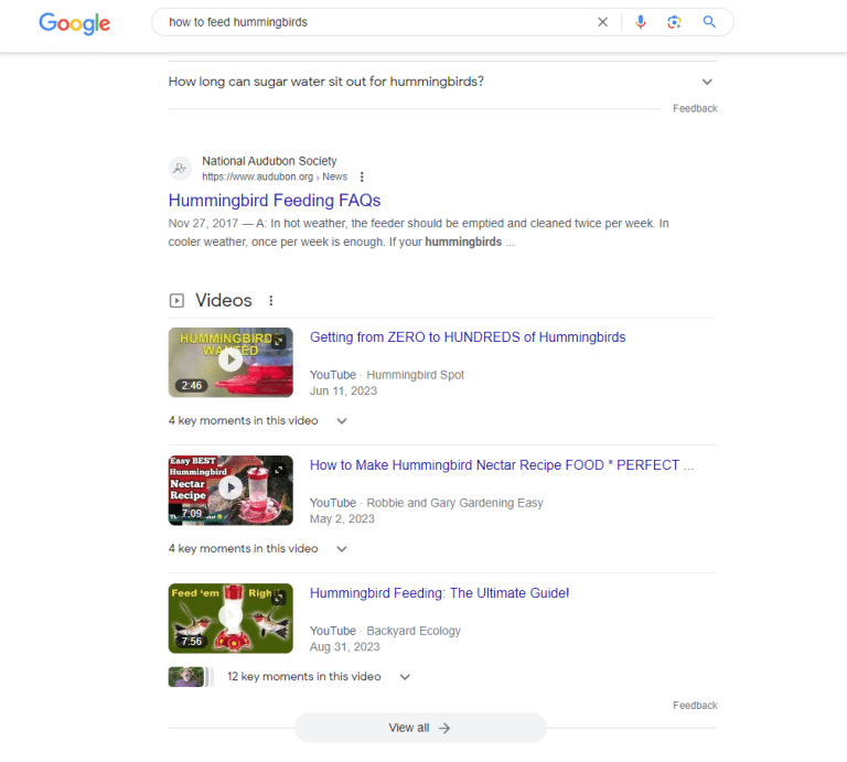 A screenshot of a SERP page for a query about feeding hummingbirds, showing a block of video results.