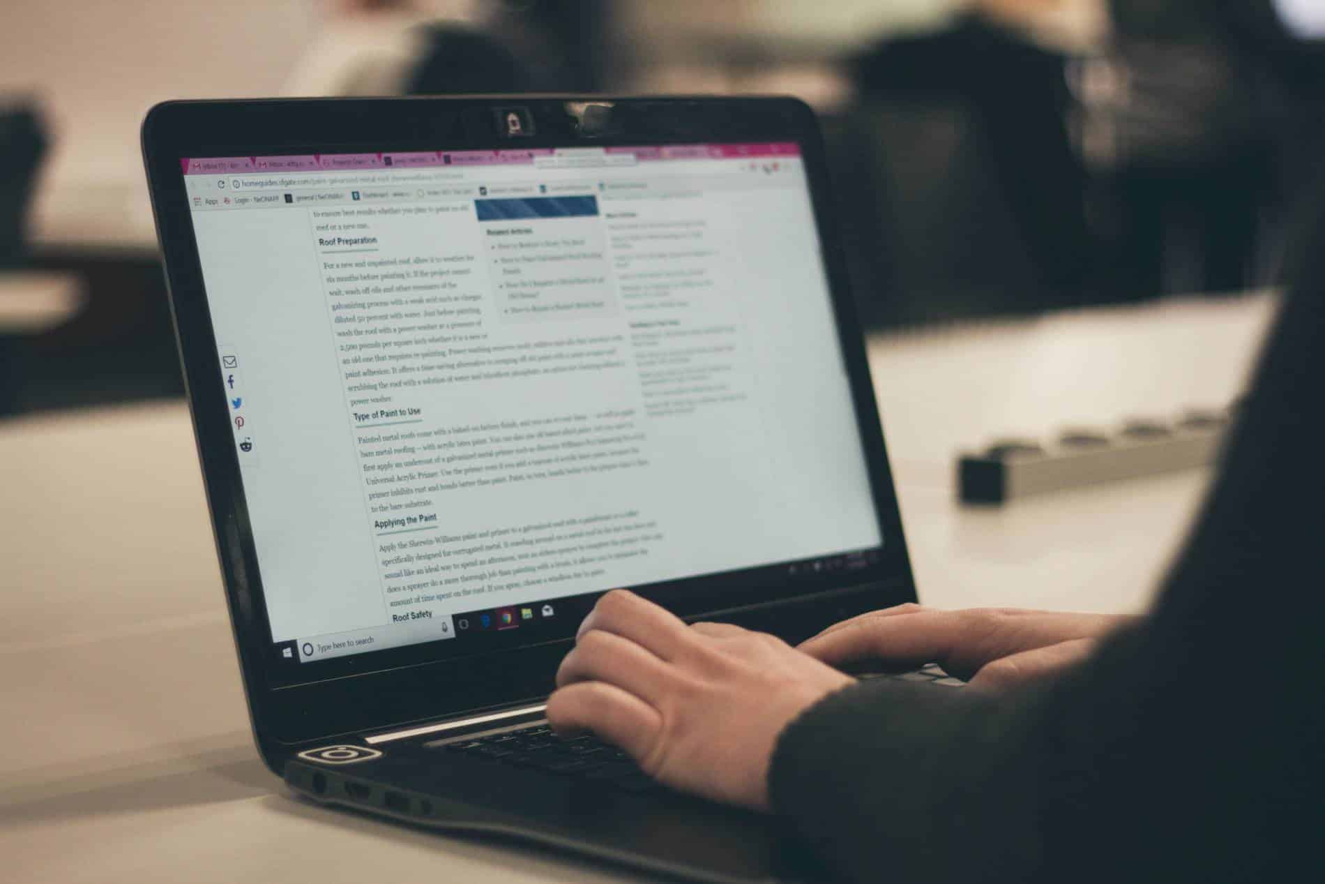 Close up of a person typing on a laptop.